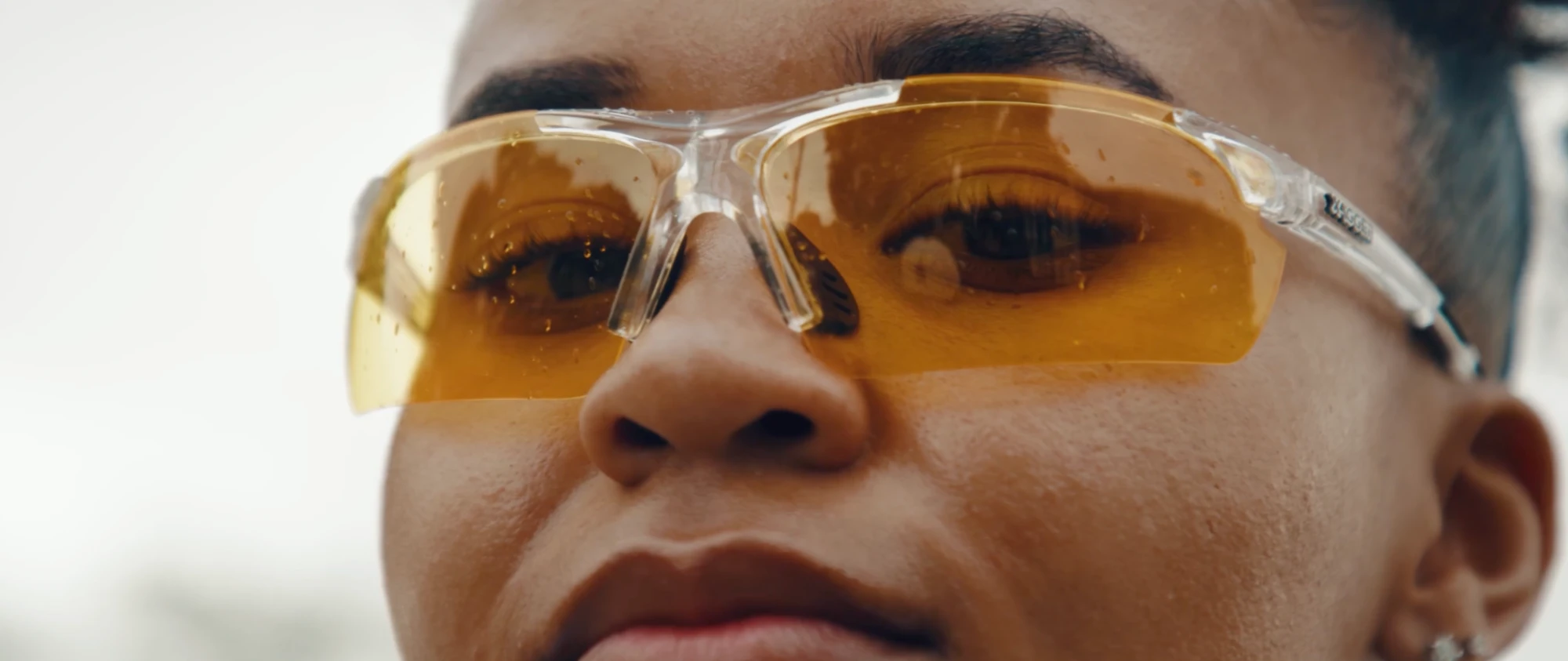 Close-up of a runner wearing amber-tinted sport glasses